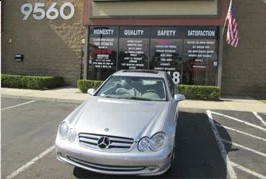 Silver Mercedes after repair, parked outside the shop